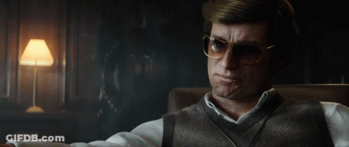 Man With Glasses Sitting In Chair Smoking Cigarette GIF