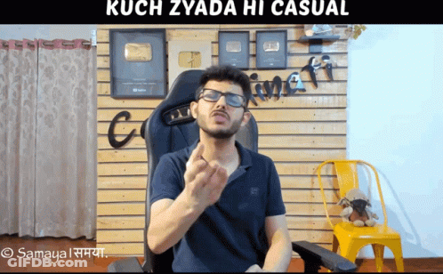 Man With Glasses Sitting In Front Of Kuch Zyada Hi Casual Wall GIF