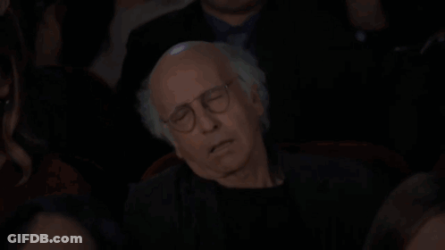 Man With Glasses Sleeping On Woman's Lap In Dark Room GIF