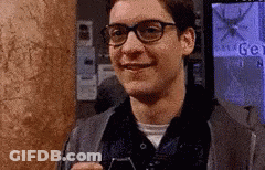 Man With Glasses Smiling Holding Cell Phone GIF