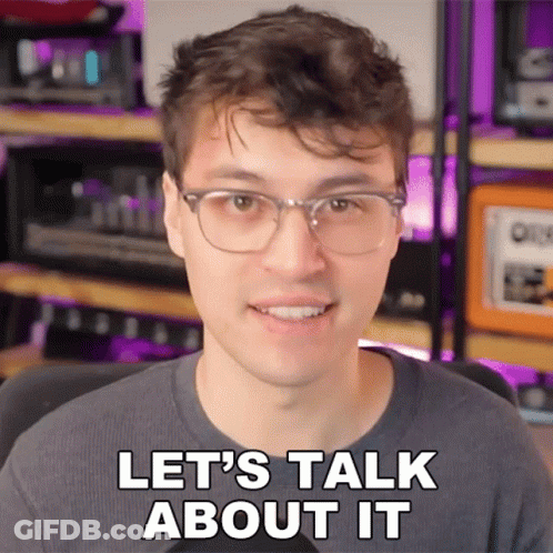 Man With Glasses Smiling Says Let's Talk About It GIF