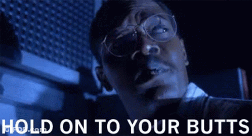 Man With Glasses Smoking Cigarette In Dark Room GIF