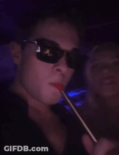 Man With Glasses Smoking Hookah In Dark Room GIF