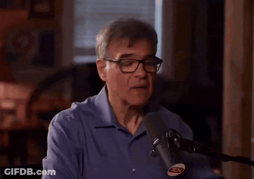 Man With Glasses Speaking Into Microphone GIF