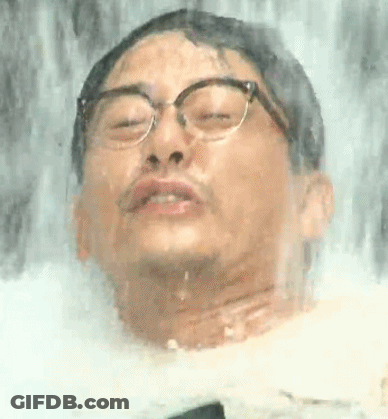 Man With Glasses Standing At Waterfall GIF