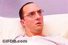 Man With Glasses Surprised In Hospital Bed GIF
