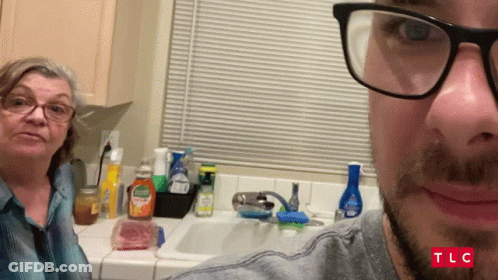 Man With Glasses Taking Selfie With Woman In Kitchen TLC GIF