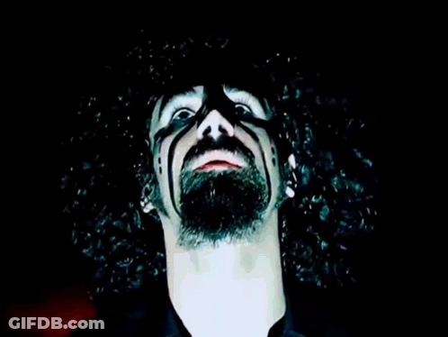 Man With Glowing Eyes And Necklace GIF