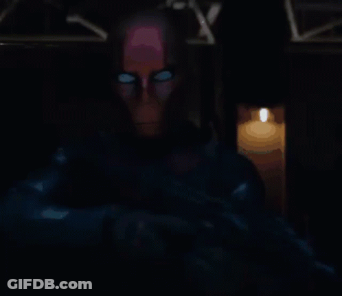 Man With Glowing Eyes Standing By Lit Candle GIF