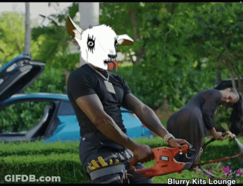 Man With Goat Mask Holding Black And Decker Hedge Trimmer GIF