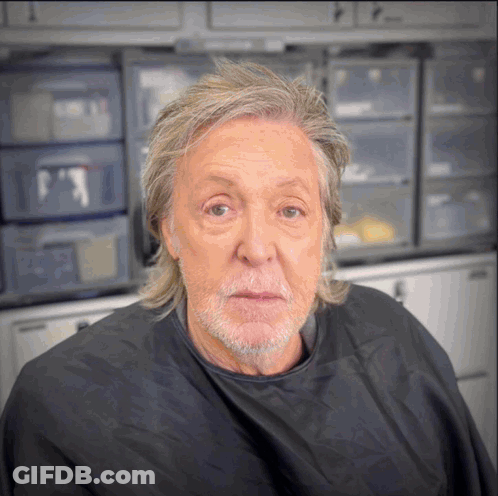 Man With Gray Hair And Beard In Black Cape GIF