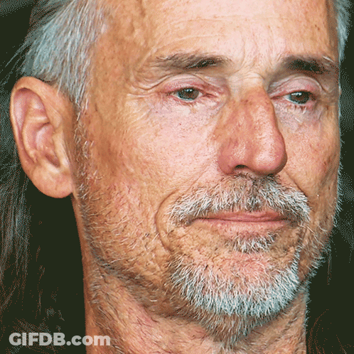 Man With Gray Hair And Beard Looking At Camera GIF