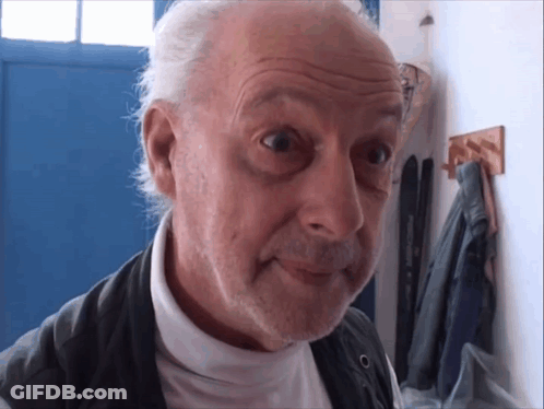 Man With Gray Hair And Beard Looking At Camera GIF