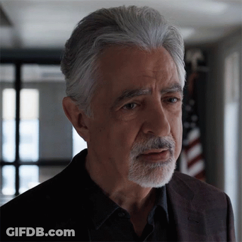 Man With Gray Hair And Beard Looks Serious GIF