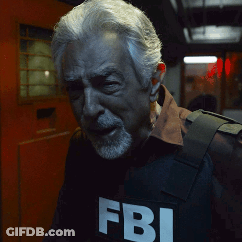 Man With Gray Hair And Beard Wearing FBI Vest GIF