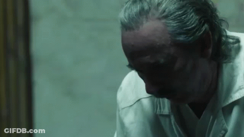 Man With Gray Hair Looking Down GIF