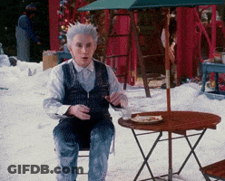 Man With Gray Hair Sitting At Table With Food GIF