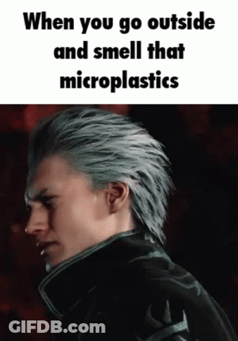 Man With Gray Hair Smelling Microplastics In Dark GIF