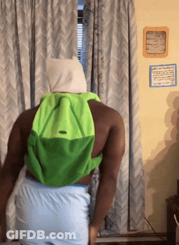 Man With Green Backpack In Front Of Window GIF