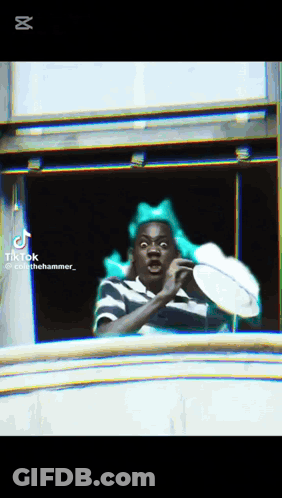 Man With Green Bow Looking Out Window GIF