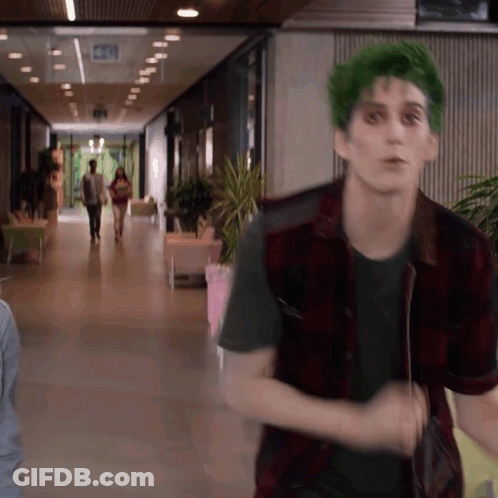 Man With Green Hair And Plaid Vest Walking GIF