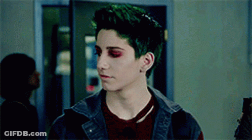 Man With Green Hair And Red Eyes In Hallway GIF