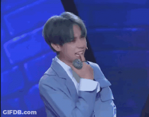 Man With Green Hair Holding Microphone And Question Mark GIF