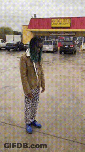 Man With Green Hair In Front Of Holy Store GIF