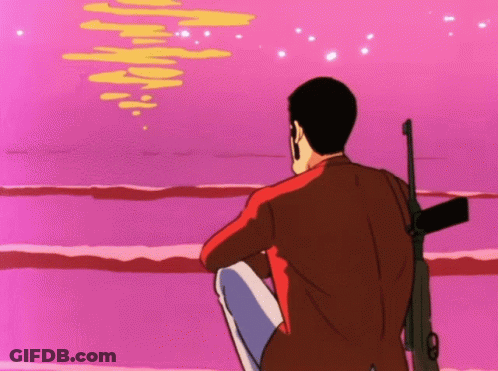 Man With Gun Sitting On Beach GIF