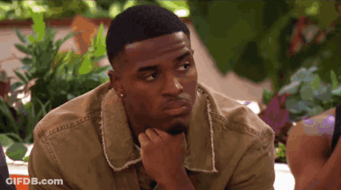 Man With Hand On Chin Looking At Camera GIF