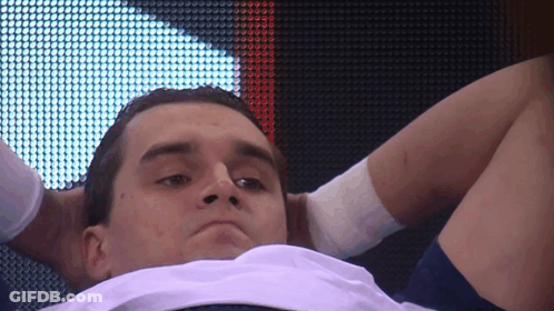 Man With Hands Behind Head Looking Down GIF