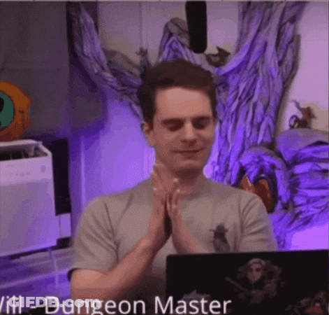 Man With Hands Folded In Front Of Dungeon Master Laptop GIF
