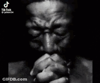 Man With Hands Folded In Front Of Face GIF