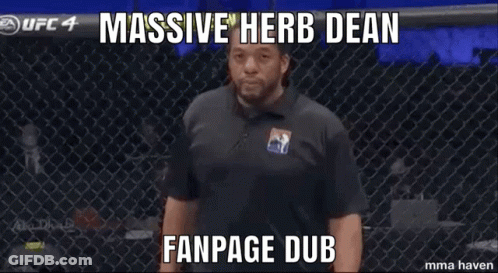 Man With Hands Folded In Front Of Fence Saying Massive Herb Dean Fanpage Dub GIF