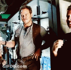 Man With Hands On Hips Next To Man In Black Shirt GIF