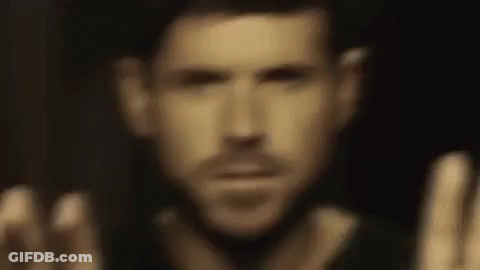 Man With Hands Up In Dark GIF