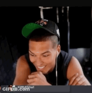 Man With Hat And Earbuds Sticking Out Tongue GIF