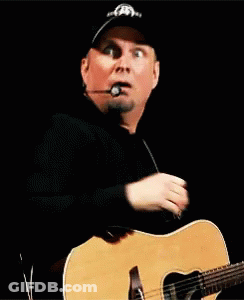 Man With Hat And Microphone Holding Guitar GIF