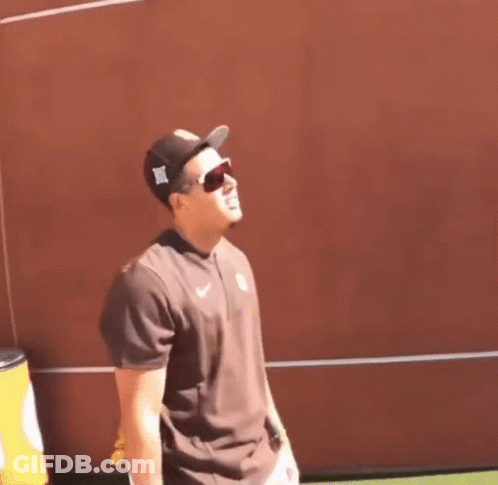 Man With Hat And Sunglasses At Red Wall GIF