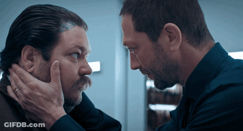 Man With Head Tattoo Looking At Another Man GIF
