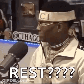 Man With Headband And Glasses Saying Rest At Mic GIF