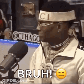 Man With Headband And Glasses Sitting At Microphone GIF