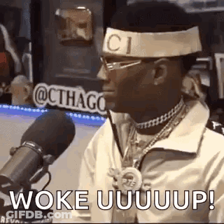 Man With Headband And Glasses Talking Into Microphone GIF