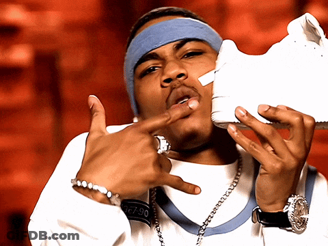 Man With Headband And Watch Holding White Shoe GIF