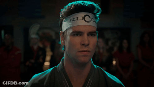 Man With Headband Letter C Looking At Camera GIF