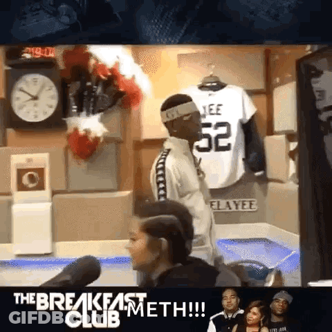 Man With Headband Number 52 In Front Of Clock GIF