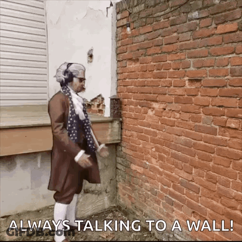 Man With Headphones Always Talking To Wall GIF