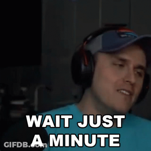 Man With Headphones And Baseball Cap Says Wait Just A Minute GIF