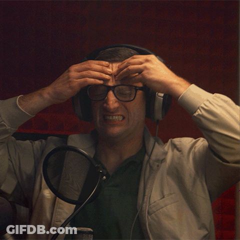 Man With Headphones And Glasses Holding Head In Pain GIF