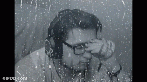Man With Headphones And Glasses Looking Out Window GIF